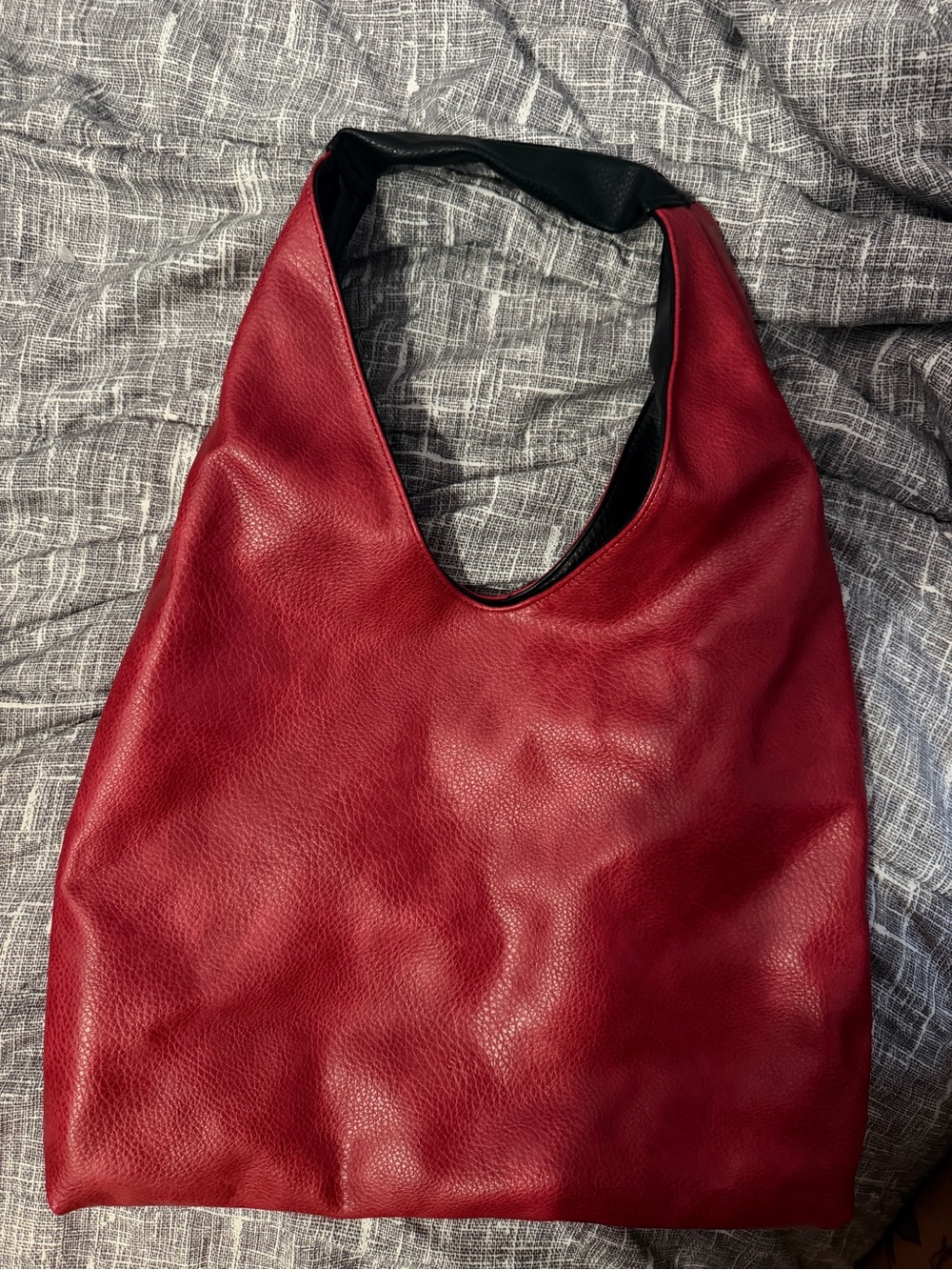 Red and black reversible shoulder bag.